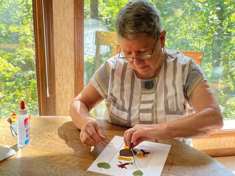 Image 2-B Ann working on flower collage at table