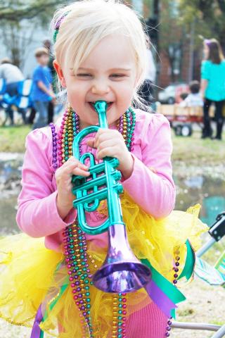 Girl playing trumpet with yellow tutu for Mardi Gras-pixabay