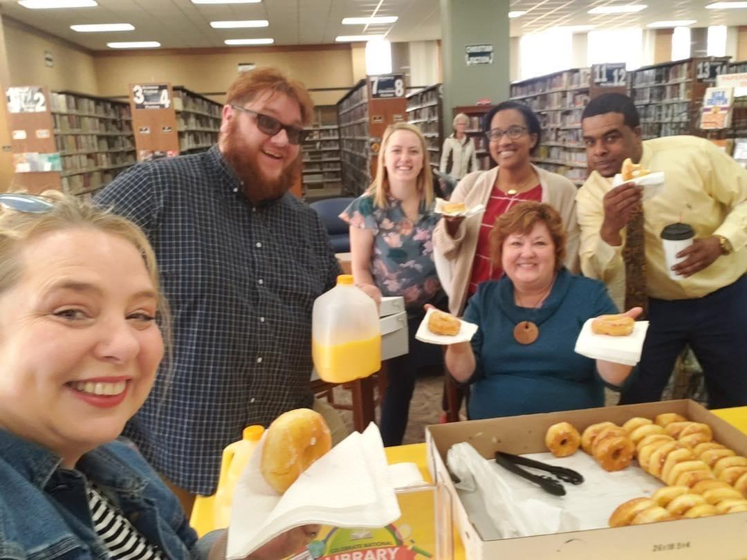 Director Claudia serves donuts!