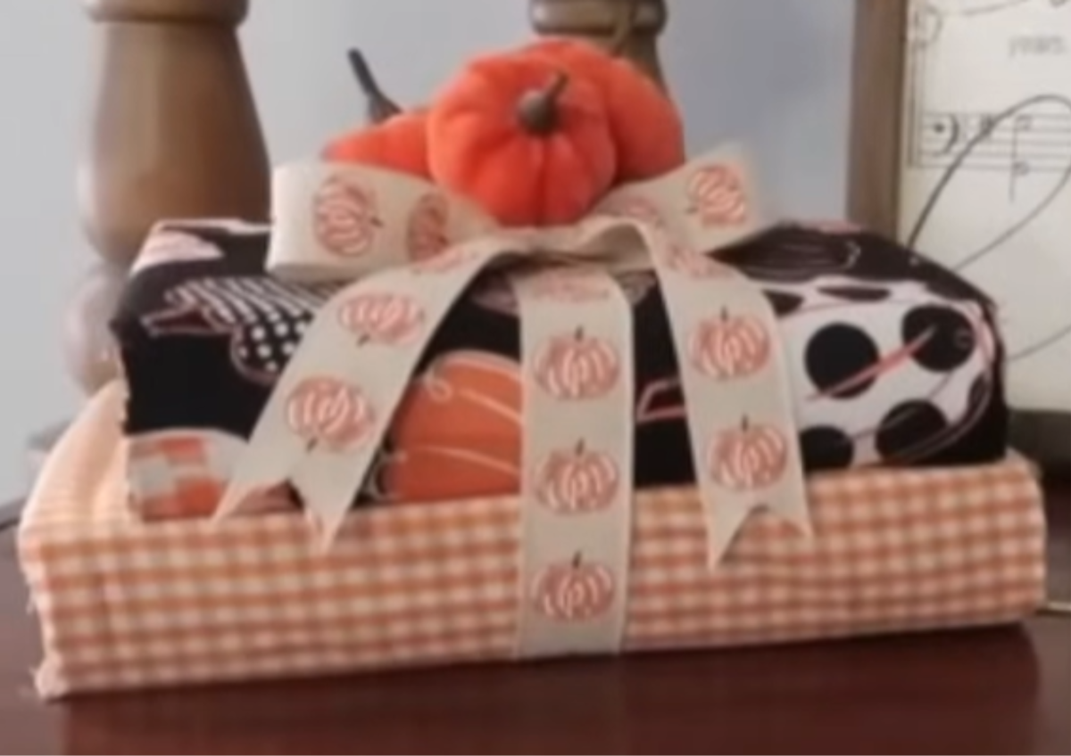 Fall Fabric Books stacked with pumpkins on top