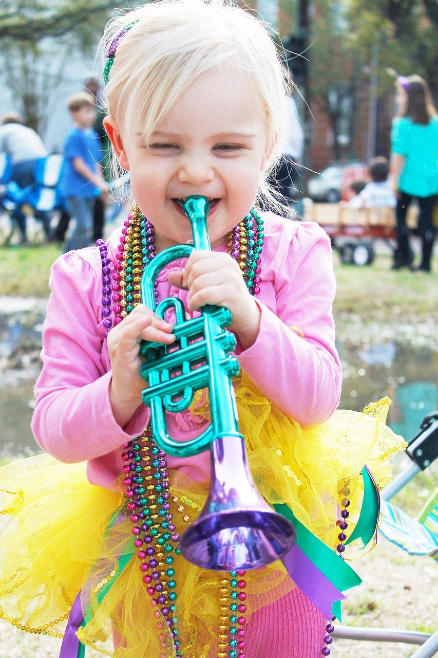 Girl playing trumpet with yellow tutu for Mardi Gras-pixabay