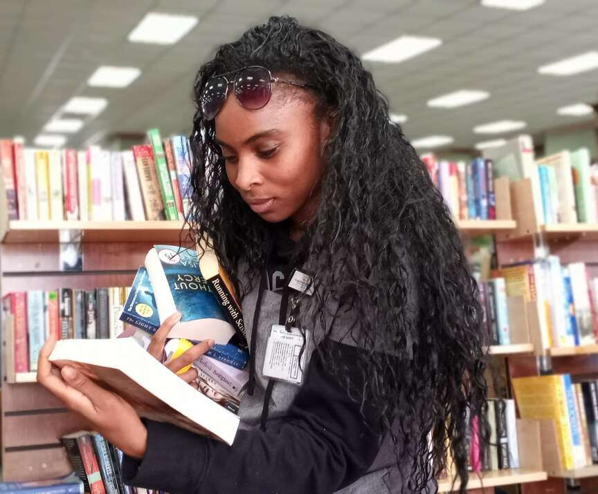 Woman looking at books 